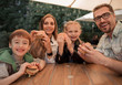 © ASDF - happy family sitting at a table in a fast food restaurant