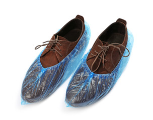 Pair of shoes in medical blue covers on white background