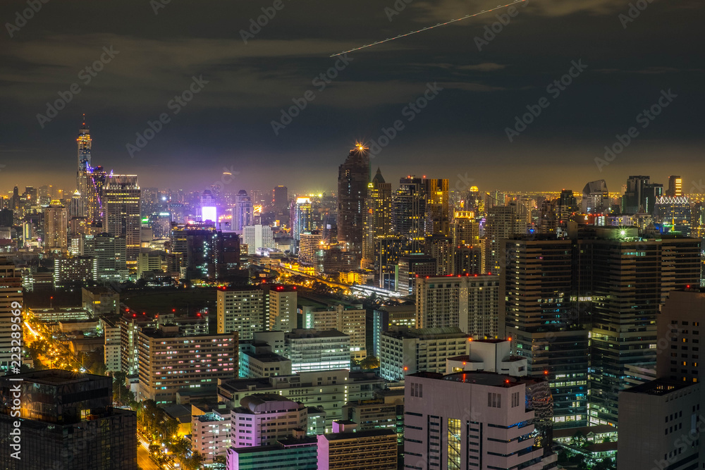 Aerial Bangkok Skyline Buildings around Silom Area with Iconic Condominium in the Cloudy day with light from the City. - obrazy, fototapety, plakaty 