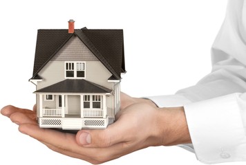 Poster - Men's Cupped Hands Holding a Model of a House - Isolated