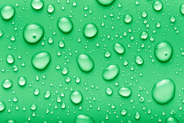 Drops of water on a color background. Green. Toned