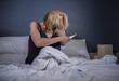 lifestyle portrait of young desperate pregnant woman using pregnancy test sad and depressed for positive result expecting unwanted baby feeling remorse