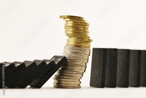 Fotografía Financial crisis concept with pile of cash money under domino effect, white back