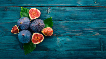 Fig. Fresh fruit figs on a blue wooden table. Free space for text. Top view.