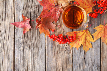 Wall Mural - pile maple leaves in corner of wooden background