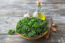 Ingredients For Salad With Kale, Onion, Garlic, Olive Oil On A Wooden Background, Rustic Style, Horizontal