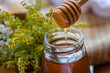 Close up of honey dropper with flower honey drop. Food ingredient and natural medicine concept.
