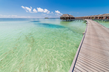  Beautiful beach with water bungalows at Maldives. Perfect beach panorama for summer travel destination banner background