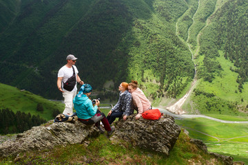 Group of tourists enjoying during summer vacation in mountains