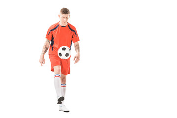 Wall Mural - athletic young sportsman in sportswear playing with soccer ball isolated on white