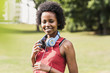 © Westend61 - Portrait of smiling sporty young woman in park