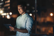 © mavoimages - Asian businessman using a tablet late at night
