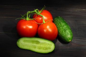 Poster - Tomatoes and cucumbers on a dark background