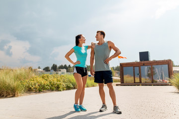 Poster - fitness, sport and lifestyle concept - happy couple in sports clothes outdoors