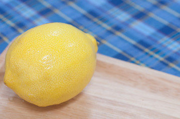 lemon on wood pan and fabric pattern background