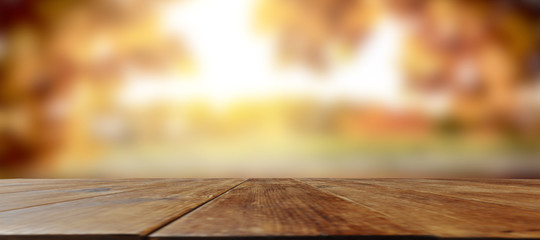 Autumnal wooden table with space for an advertising product  