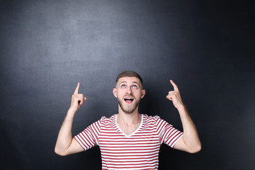 Poster - Portrait of young man on blackboard background