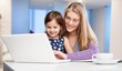 © BillionPhotos.com - Beautiful mother and cute daughter using laptop