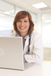 © Mark Adams - Portrait of young woman doctor in white coat at computer