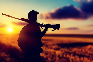 Male Hunter with Rifle on natural background