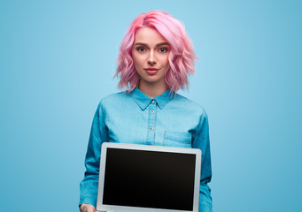 Stylish hipster woman showing laptop