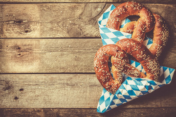 Poster - Oktoberfest concept - pretzels on rustic wood background, top view