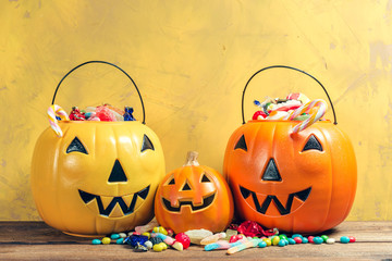 Happy halloween! Pumpkin with candy in the home.