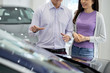 © DragonImages - Husband telling all advantages of car he is going to buy