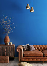 Simple Urban Style Interior With Brown Sofa And Blue Wal.