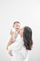motherhood and lifestyle concept. smiling young mother with little baby at home