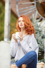 Wall Mural - Outdoors autumn portrait of beautiful woman with red hair