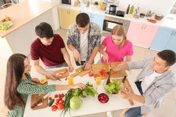 Friends cooking together in kitchen