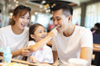 © Tom Wang - Happy family  enjoying dinner in restaurant.