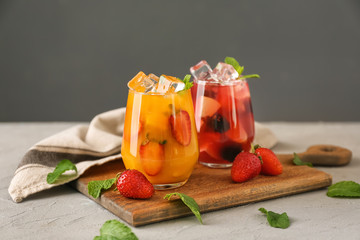 Fresh summer cocktails in glasses on wooden board