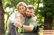© Pixel-Shot - Man in wheelchair with beautiful woman dancing outdoors