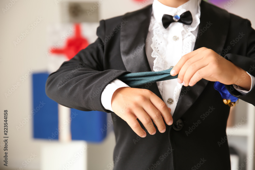 Cute little magician showing trick indoors, closeup