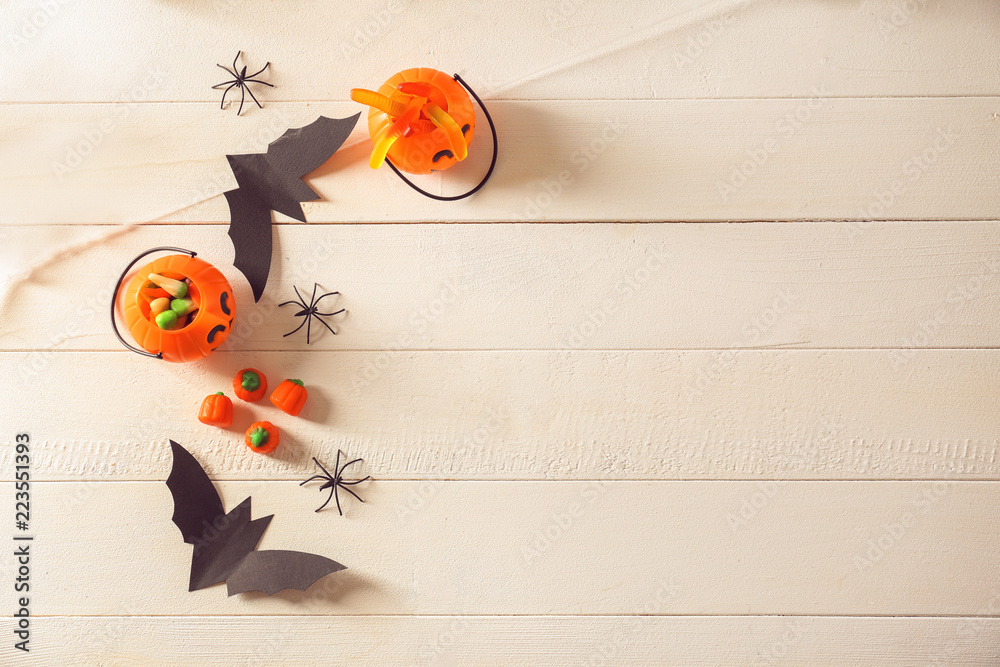Creative decorations for Halloween party on white wooden background