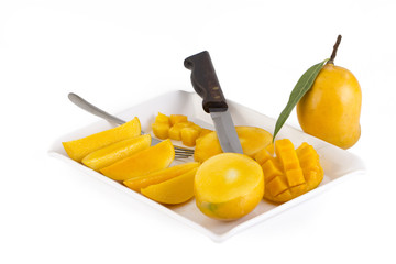 Wall Mural - Mangoes cut into slices in a tray isolated on white background