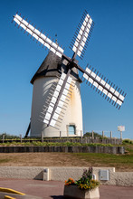 Beautiful White Windmill, The Background Of Blue Sky.