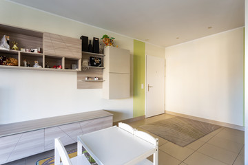 Entry with a white wall and a game table for children