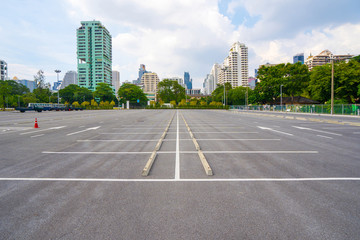 Empty parking lot with city in the background and beautiful blue sky