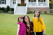 © Ursula Page - Mom and Two Daughters Being Silly Having Fun Laughing Outside Their Home