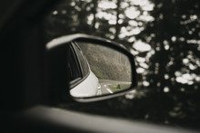 Close-up Of Side-view Mirror Seen Through Car Window