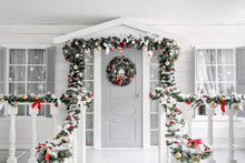 Christmas Morning. Porch A Small House With A Decorated Door With A Christmas Wreath. Winter Fairy Tale.