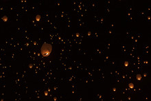 Low Angle View Of Illuminated Paper Lanterns Flying Against Sky At Night During Chinese New Year