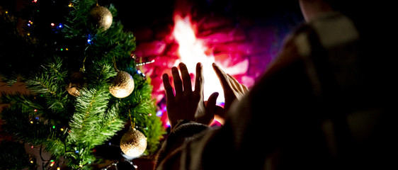 close up wet frozen  teenager under the blanket warm up hands at the home fireplace  f