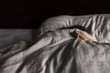 © Cavan Images - Sick girl with blanket sleeping on bed at home