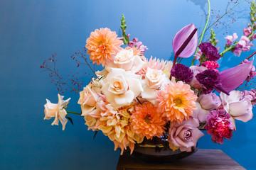 Wall Mural - Background with bouquet of pink in glass vase on blue background. Bouquet of chrysanthemums as decoration.