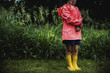 © Cavan Images - Girl in raincoat standing in park