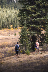 Wall Mural - A couple walking on a mountain path in Colorado during fall. 